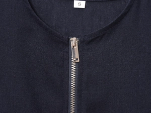 Detailed macro of a navy linen blend jacket showing the metal zipper and size S label