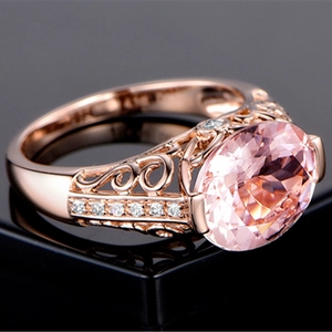 Close-up of pink oval morganite ring set in 18K rose gold with side diamond accents