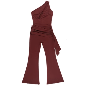 Detail of burgundy off-shoulder jumpsuit with waist pleats and flared trousers