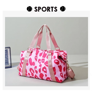 Close-up of pink leopard print travel bag with durable straps and waterproof fabric