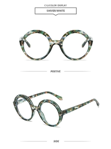 Macro view of vintage round frame sunglasses with green and white marble texture details