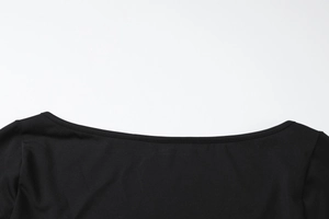 Close-up of the stitching details and ribbed texture on a black off-shoulder neckline