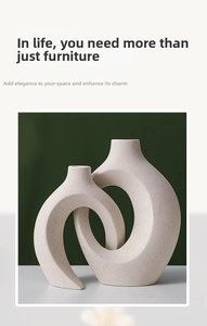 Close-up of interlocking Nordic ceramic white vases with matte speckled texture design