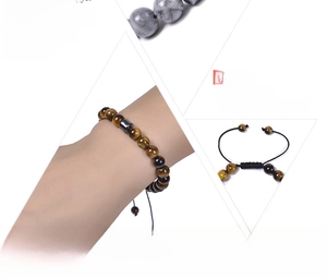 Macro detail of 8mm natural tiger eye stone beads and adjustable braided cord bracelet