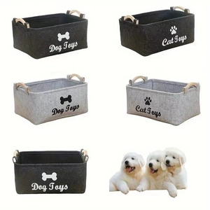 Close-up of felt pet toy storage bins with wooden handles in gray and charcoal colors