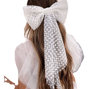 Elegant white tulle bow hair clip with pearls and polka dots on long hair