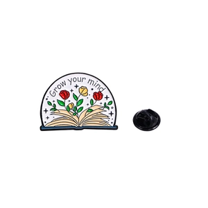 Cartoon floral book enamel pin featuring Grow your mind text on a white background