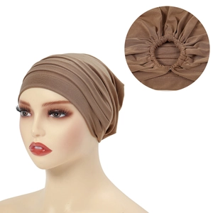 Detail showing elastic band construction of brown pleated turban headscarf on model