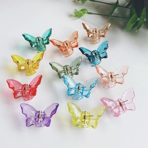 Set of 12 colorful butterfly acrylic hair clips in transparent resin on white background