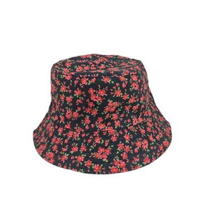 Detail showing the floral pattern texture and top view of the black cotton bucket hat