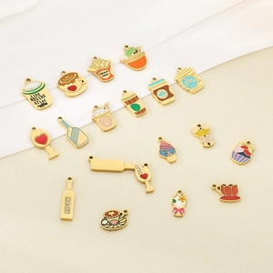 Macro shot of assorted colorful enamel charms for DIY jewelry making on beige fabric