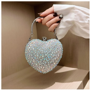 Macro view of crystal encrusted heart evening bag with sparkling rhinestones and metal handle
