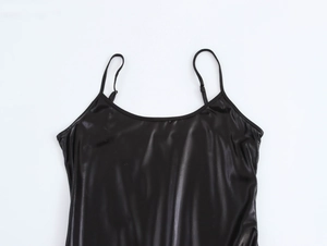 Detailed close-up of a black sequin拼接 dress showing the smooth shiny fabric and straps
