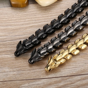 Macro shot of stainless steel dragon head bracelets in black, dark grey, and gold finishes