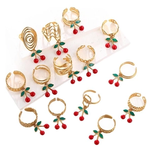 Detailed macro view of 13-piece gold-tone cherry pendant rings with colorful enamel charms
