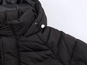 Close-up of black hooded puffer jacket showing drawstring and metal adjustment buckles