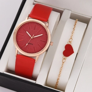 Detail of red leather quartz watch and gold heart bracelet set in a gift box