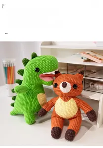 Detail of hand-knitted green dinosaur and orange fox plush dolls with crochet texture
