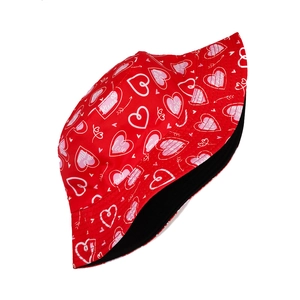 Detail of red Valentine bucket hat with heart prints and Love Kisses text patterns
