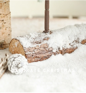 Close-up of a rustic mini Christmas tree base made of real wood with decorative snow