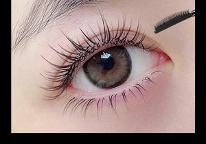 Close-up of curved mascara brush lifting and defining thick lashes for a curling effect