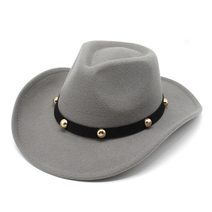 Detail of gray wool fedora hat featuring black band with gold metal studs