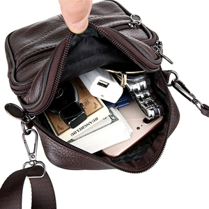 Men's dark brown leather shoulder bag showing spacious interior with daily essentials