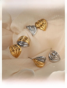 Macro shot of 316L stainless steel earrings featuring textured shell heart shapes