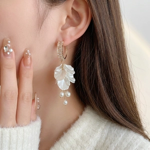 Elegant gold petal tassel earrings with zircon and pearls on model for a luxury look