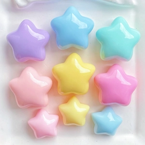 Close-up of colorful resin star charms for DIY crafts in various pastel sizes and shades