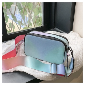 Detail of pink and blue gradient camera bag with dual zippers and wide shoulder strap