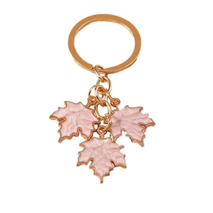 Fashionable gold keychain with pink maple leaf pendants and elegant enamel finish