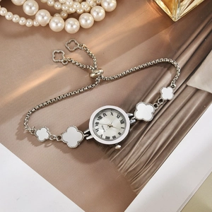 Detail of silver clover bracelet watch with Roman numerals dial and pearl decor