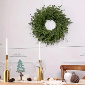 Detailed view of artificial Christmas garland hanging on a white French-style wall