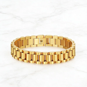 Classic gold stainless steel watch-strap bracelet with three-link design on marble surface