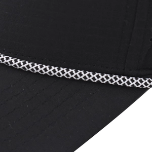 Detail of black sports cap featuring breathable mesh fabric and a checkered decorative cord