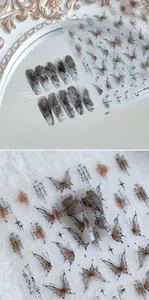 Detail of embossed butterfly and bamboo nail stickers with artistic ink calligraphy