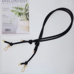 Detail of 6mm black leather DIY strap featuring golden swivel hooks and knot design