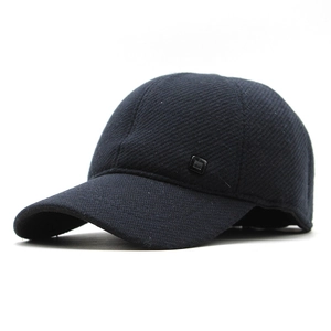 Detailed view of heavy fabric texture and small black ornament on navy baseball cap