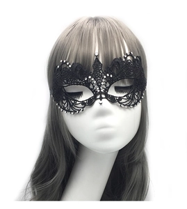 Detailed view of black lace masquerade mask with sparkling rhinestones on a mannequin