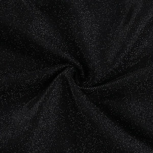 Detailed close-up of sparkly black fabric with silver glitter for a luxury dress