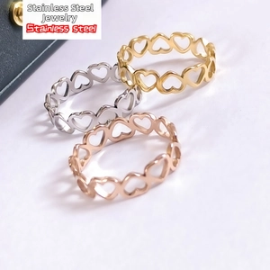 Detailed view of heart-shaped cutout rings in gold, silver, and rose gold finishes