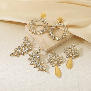 Golden stainless steel earrings set with round floral patterns and sparkling rhinestones