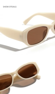 Detail of cream rectangular sunglasses with thick temples and dark brown lenses