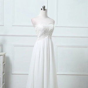 Elegant white strapless wedding dress with heart-shaped lace bodice and chiffon skirt