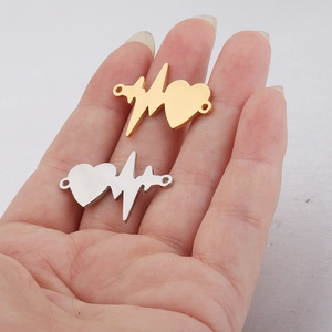 Close-up of gold and silver heartbeat pulse connectors for DIY jewelry making