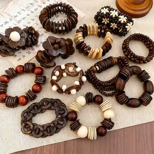 Ethnic retro coconut shell and wood bead bracelets set on a linen background