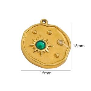 Detailed view of a 15mm round gold pendant with green gemstone and sunburst texture