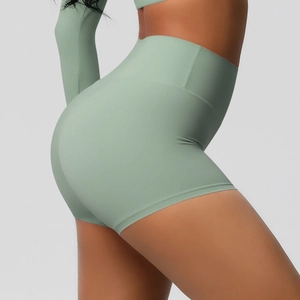 Close-up of mint green high-waisted yoga shorts with seamless stitching and body contouring