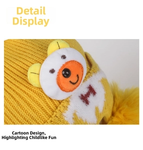 Detail of yellow knit hat featuring a cute bear patch and soft faux fur pom-pom